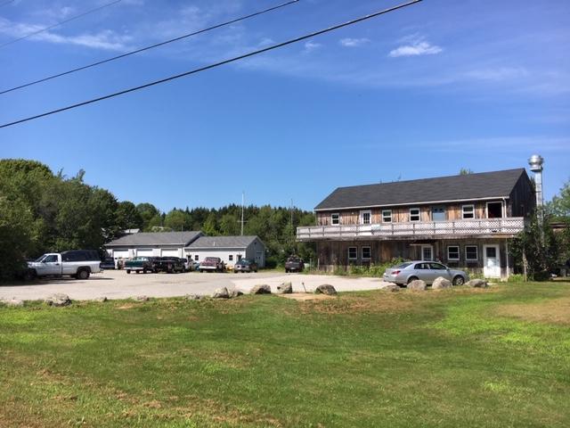 3,000+/- SF Com. Bldg/Store with (4) Apts - 2,148+/- SF Garage (7) Storage Units Auction